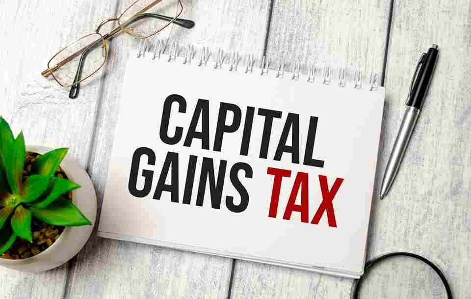 capital-gains-tax-words-notebook-pen-glasses